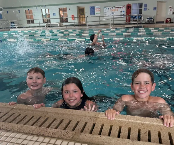 Youth swimming inside indoor pool