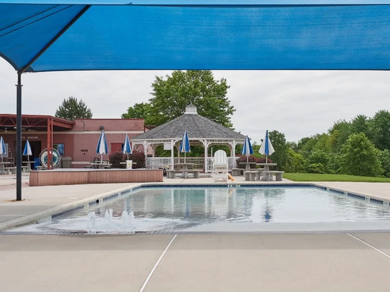 Outdoor pool area with canopy and gazebo at Spring Valley Y