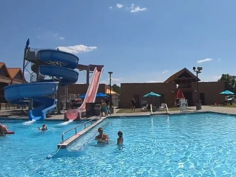 Outdoor pool area with slides at Ambler Y