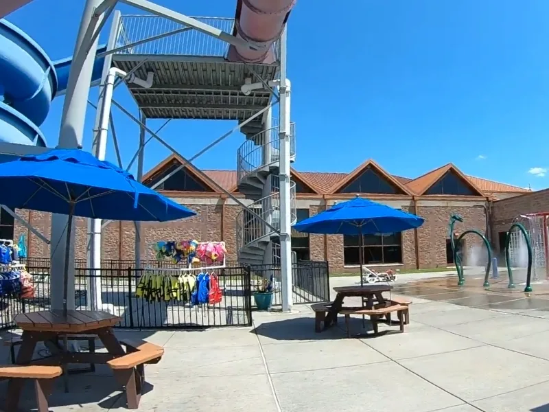 Outdoor pool area with kids splash pad at Ambler Y
