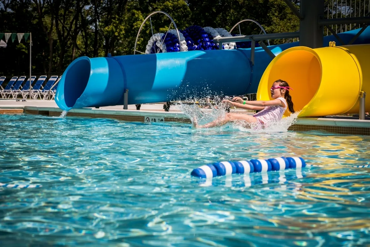 Child coming out of slide at outdoor pool