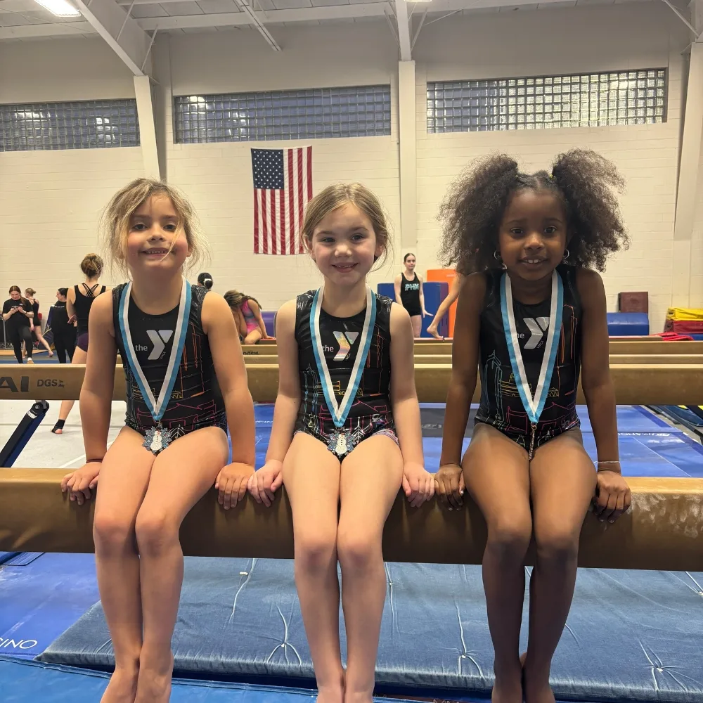 Phoenixville Y's youth gymnastics team at competition inside gymnastics facility