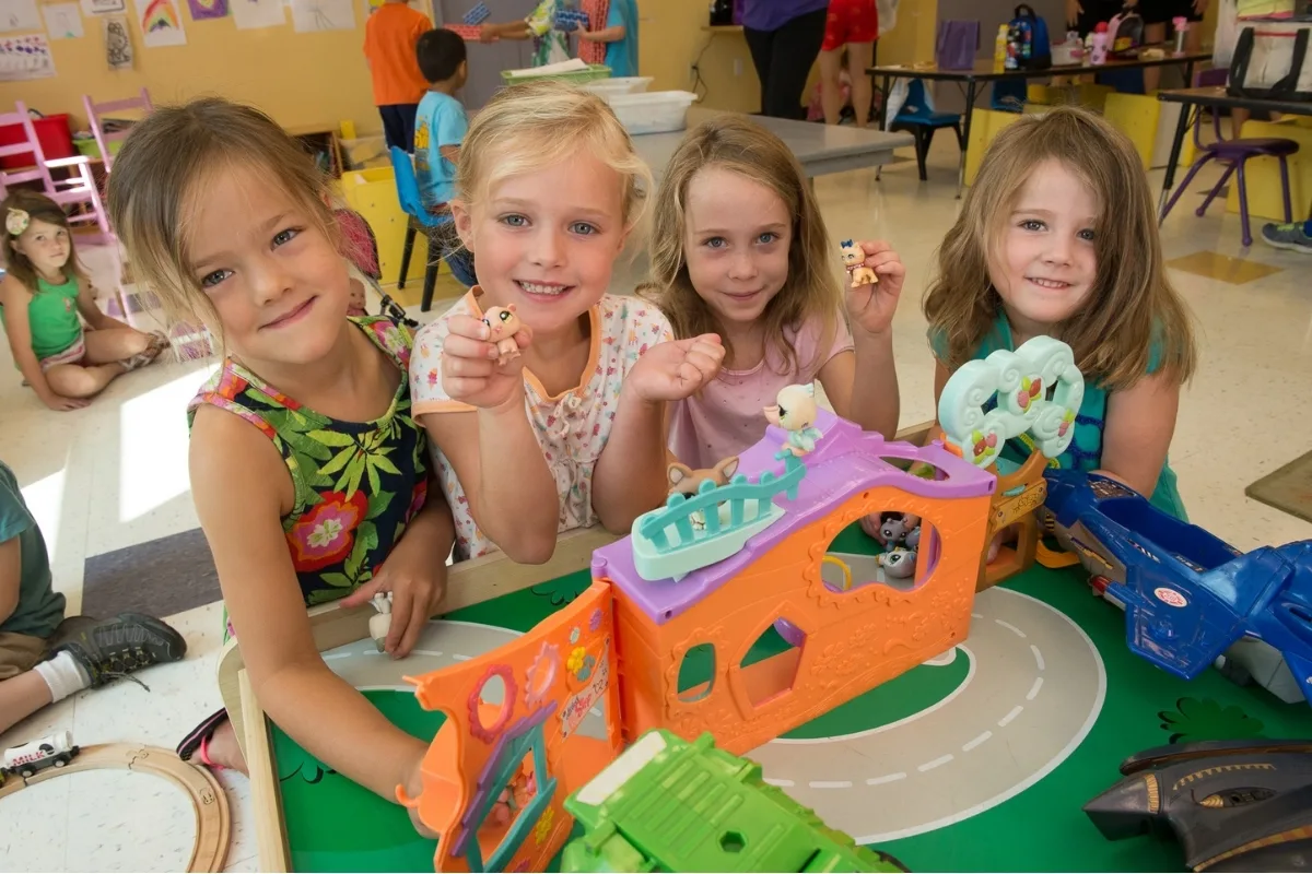 Group of children playing with toys in a classroom
