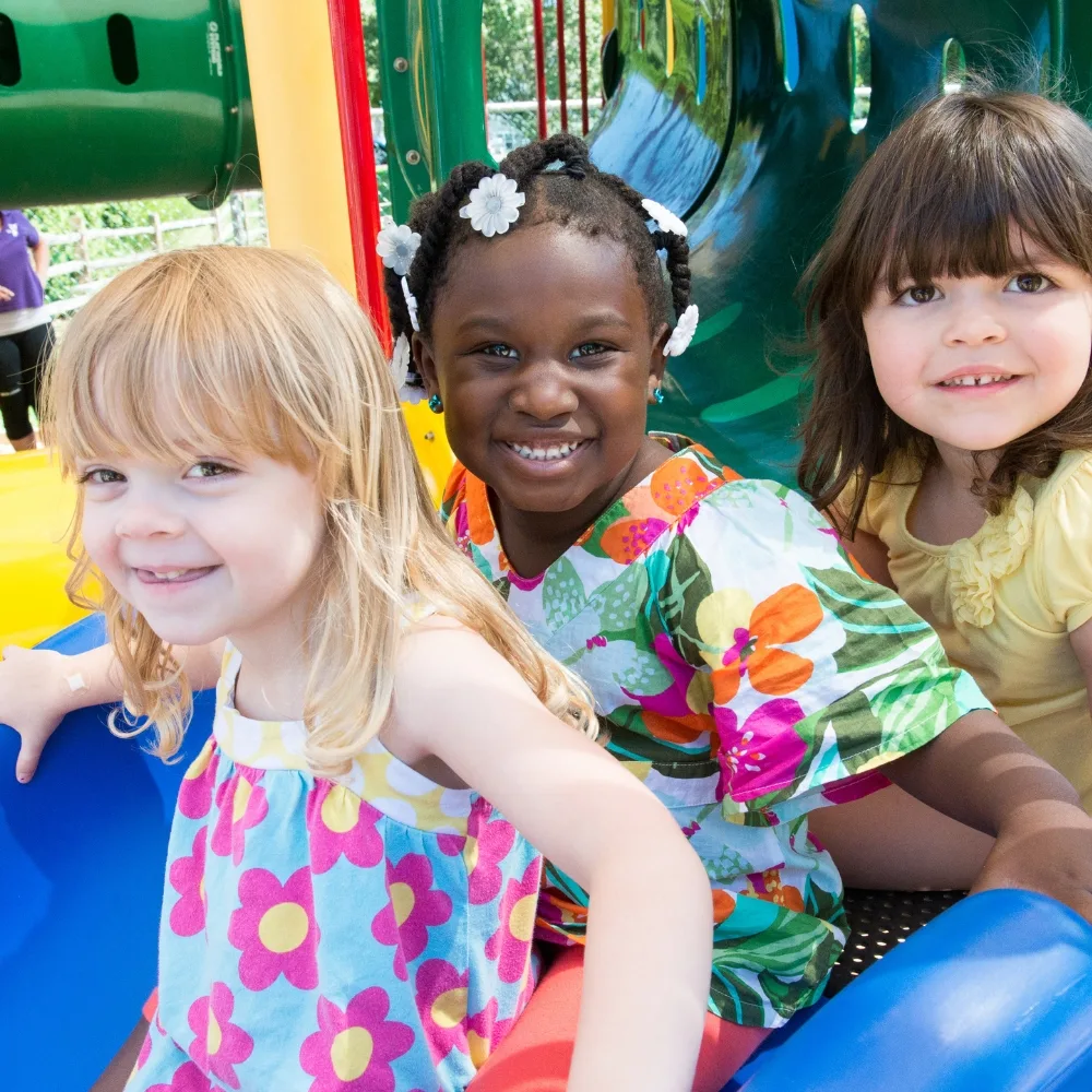 Group of children playing on playground equipment outdoors