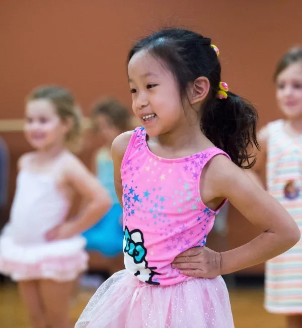 Child practicing dance inside a studio