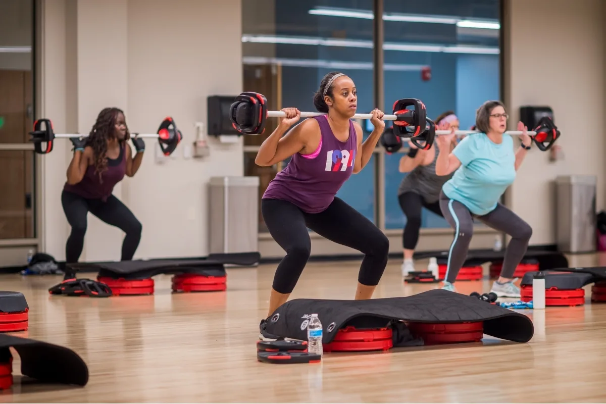 Group exercise weight training inside a studio