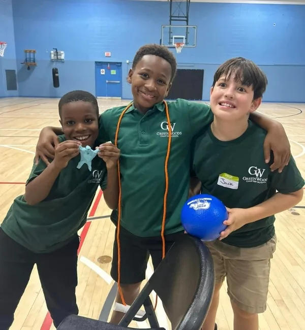 Children with sports equipment inside gymnasium