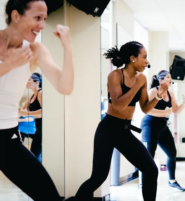 Small group body combat training class inside studio