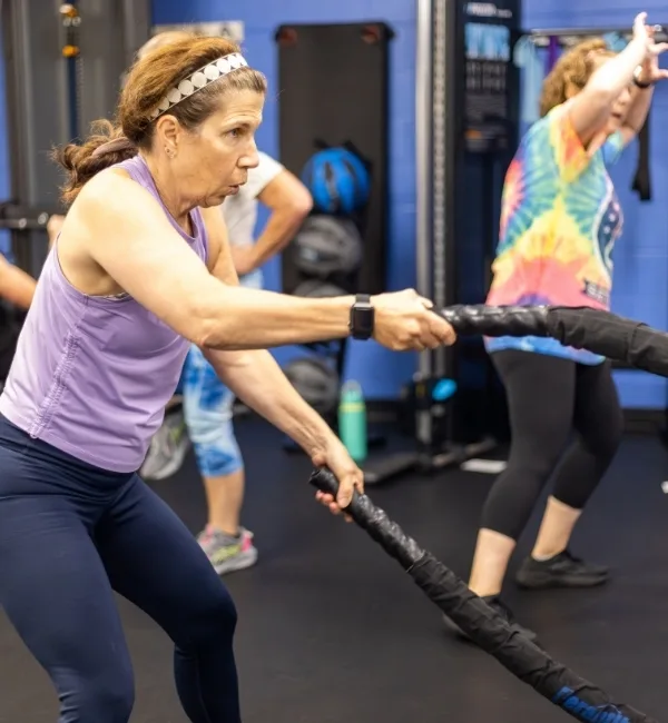 Small group Shock class using exercise equipment in fitness center