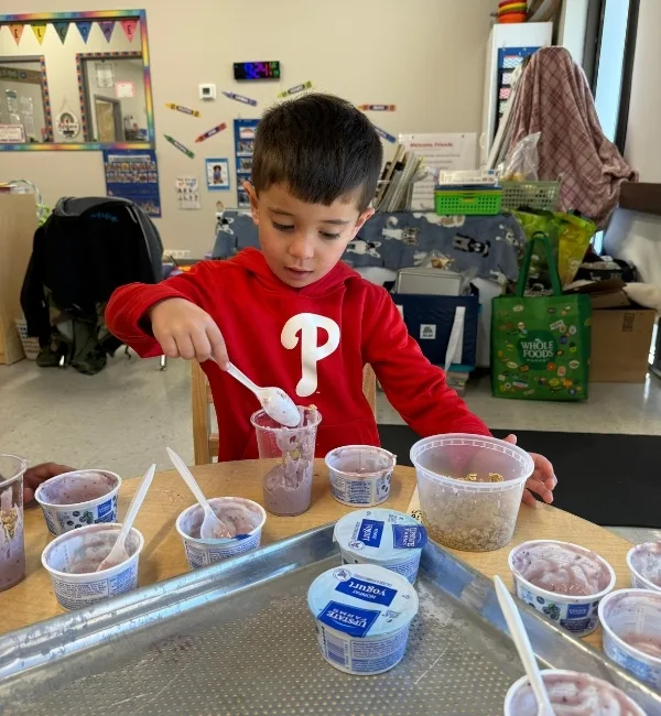 Child making food in classroom
