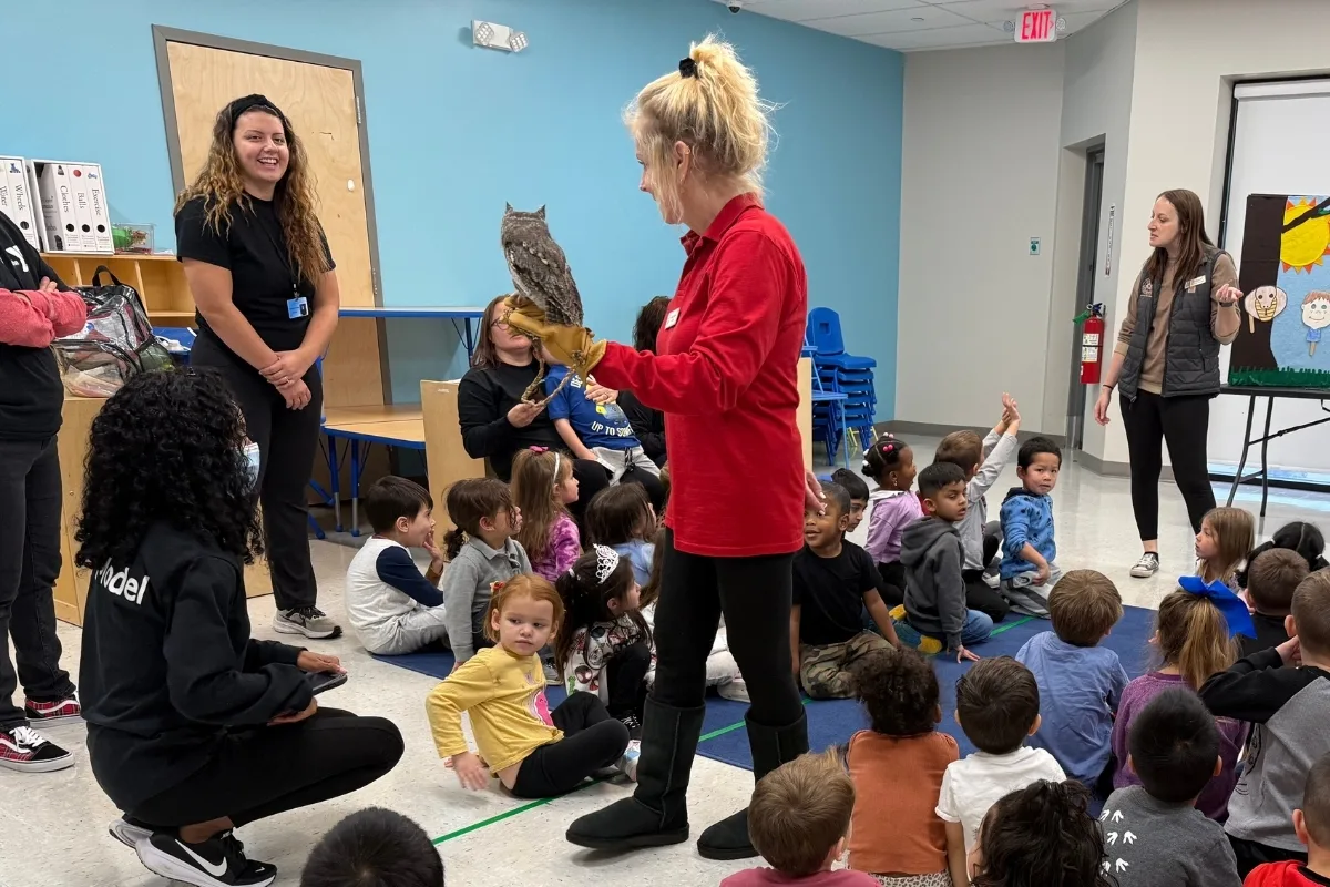 Group of children with Pre-K staff members watching live animal demonstration