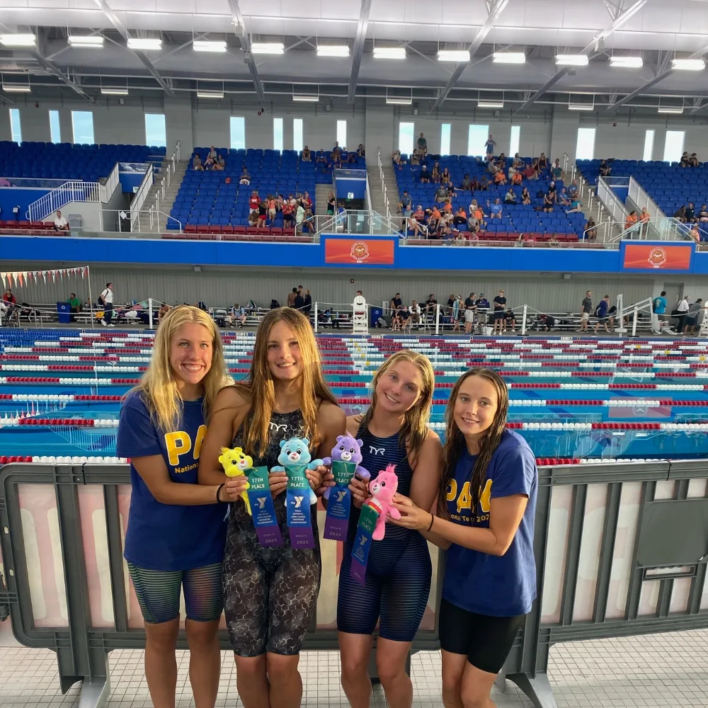 Phoenixville Y's swim teammates at an indoor swim competition