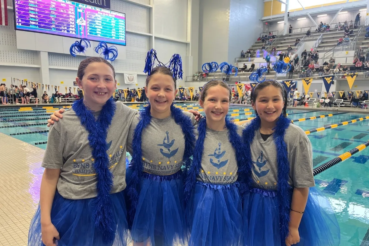 Swim teammates at an indoor swim competition