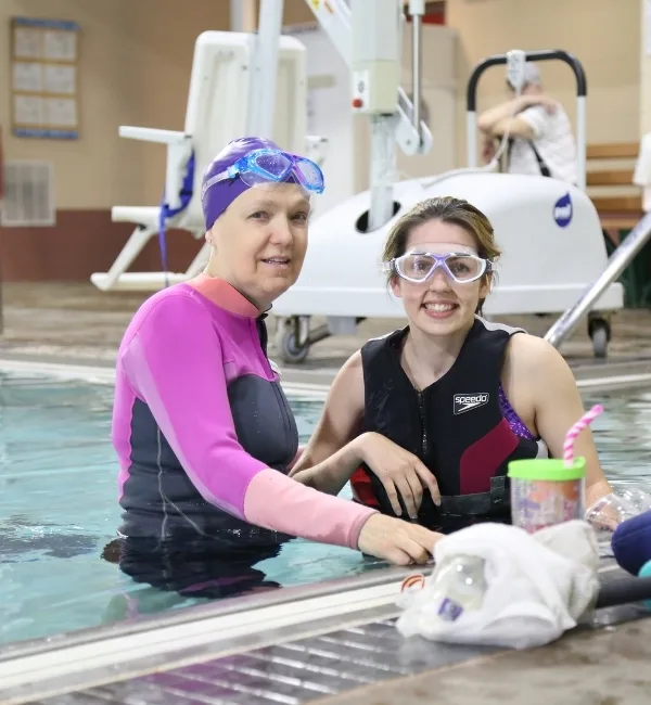 Adaptable swim instructor teaching swim lessons