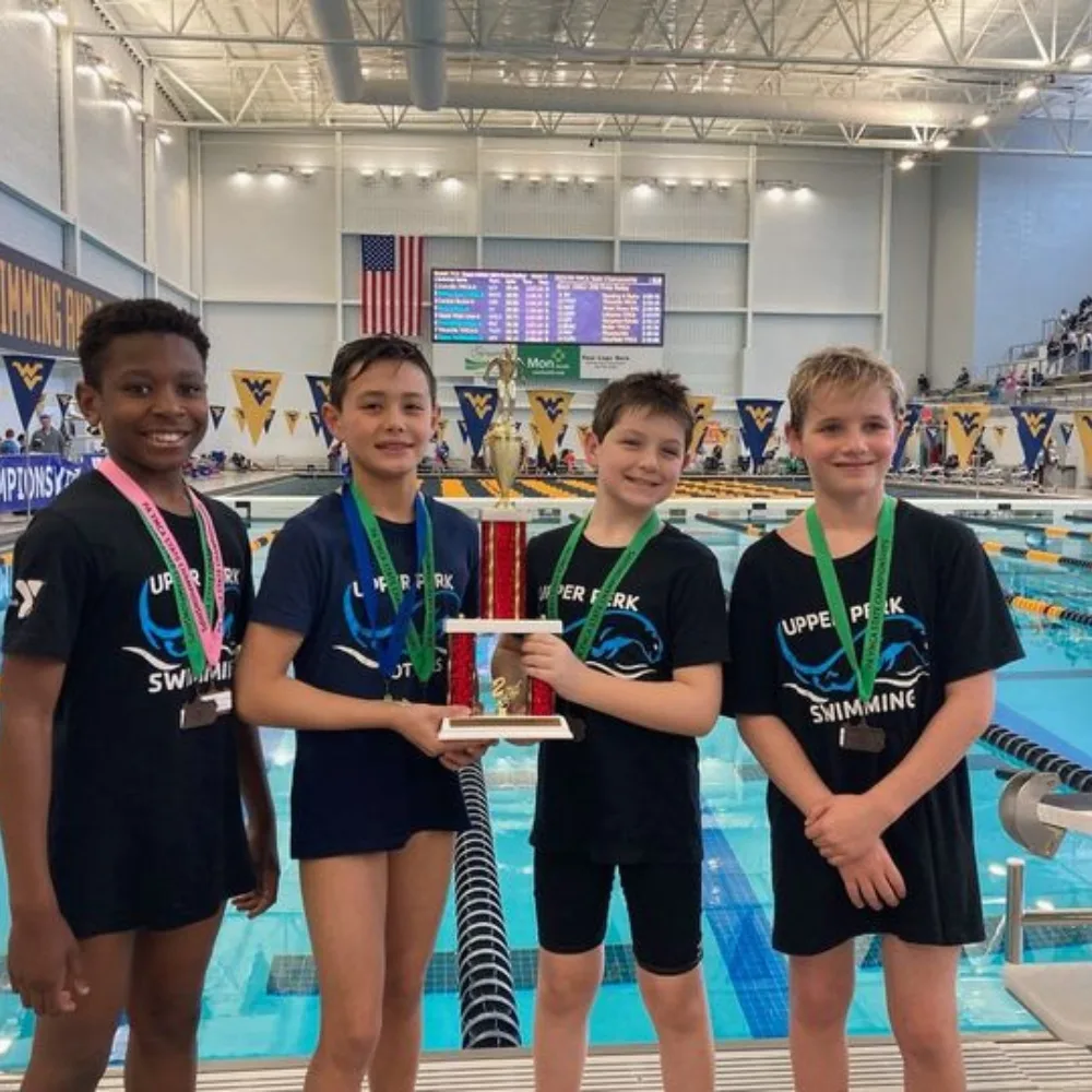 Youth swim team winning swim competition at an indoor pool