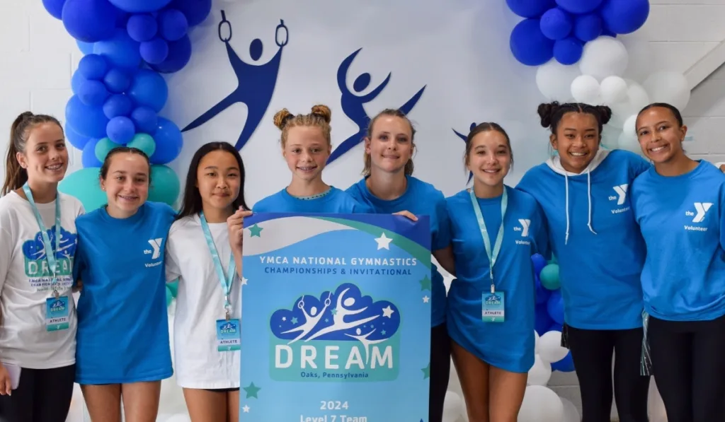 Y volunteers and youth gymnastics athletes at gymnastics competition
