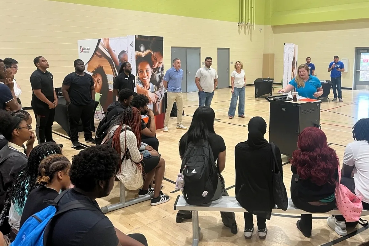 Teens at a Teen Workforce Development presentation inside gymnasium